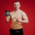 Olimp Sport Nutrition Amino EAA Man holding Tub Photo