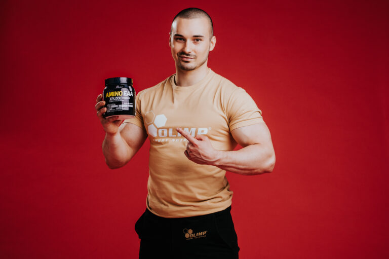 Olimp Sport Nutrition Amino EAA Man holding Tub Photo