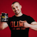 Olimp Sport Nutrition Amino EAA Man holding Tub Photo