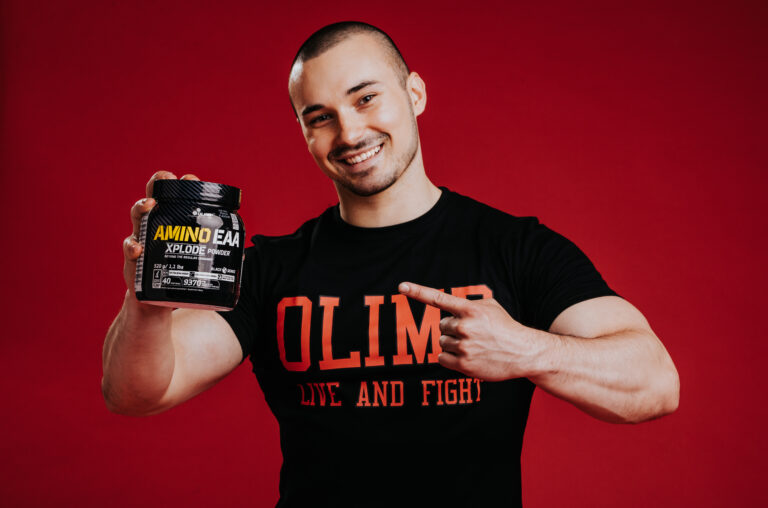 Olimp Sport Nutrition Amino EAA Man holding Tub Photo