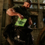 A man taking Olimp Sport Nutrition Carbo Nox out of a bag